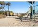 Playground on the beach featuring a slide, play equipment, palm trees, and an 'I Heart HOLI' sign at 6001-Z-26 South Kings Hwy., Myrtle Beach, SC 29575