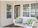 Relax on this cozy porch swing with decorative pillows, enhanced by natural light from the windows at 6001-Z-26 South Kings Hwy., Myrtle Beach, SC 29575