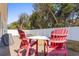 Relaxing back yard featuring Adirondack chairs and a table on a brick patio, perfect for entertaining at 606 5Th Ave. S, North Myrtle Beach, SC 29582