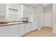 Bright kitchen with white cabinets, neutral countertops, stainless steel appliances, and tile flooring at 606 5Th Ave. S, North Myrtle Beach, SC 29582