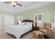This main bedroom features a ceiling fan, two windows with shutters, and an adjacent sitting area at 606 5Th Ave. S, North Myrtle Beach, SC 29582