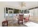 Inviting screened porch features a ceiling fan, tile floors, and comfortable seating for relaxation at 606 5Th Ave. S, North Myrtle Beach, SC 29582
