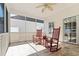 Cozy screened porch with comfortable rocking chairs and tile flooring, perfect for enjoying the outdoors at 606 5Th Ave. S, North Myrtle Beach, SC 29582