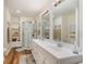 Updated bathroom featuring a double vanity, a glass enclosed shower, and hardwood floors at 613 Calhoun Dr., Murrells Inlet, SC 29576
