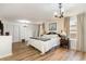 This bright bedroom features hardwood floors, an updated chandelier, and plenty of closet space at 613 Calhoun Dr., Murrells Inlet, SC 29576