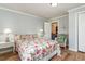 Cozy bedroom featuring a floral patterned bed set, a corner chair, and hardwood floors at 613 Calhoun Dr., Murrells Inlet, SC 29576