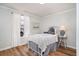 Inviting bedroom featuring white bedding, light wood-look floors, and natural light at 613 Calhoun Dr., Murrells Inlet, SC 29576