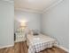 Cozy bedroom with a twin bed, side table with lamp, and light wood-look floors at 613 Calhoun Dr., Murrells Inlet, SC 29576