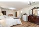 Spacious main bedroom featuring wood floors, a dresser, a comfy bed, and ample space at 613 Calhoun Dr., Murrells Inlet, SC 29576