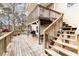 Spacious wooden deck featuring stairs, a grill, and an area for outdoor dining at 613 Calhoun Dr., Murrells Inlet, SC 29576