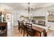 Bright and airy dining area with wood floors, white cabinets, and a rustic wooden dining table with seating at 613 Calhoun Dr., Murrells Inlet, SC 29576