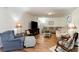 Bright and airy living room with a cozy blue accent chair, wood floors, and plenty of space at 613 Calhoun Dr., Murrells Inlet, SC 29576