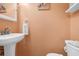 Small half-bathroom with pedestal sink, toilet and beach decor at 614 15Th Ave. S # 42, Surfside Beach, SC 29575