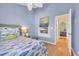 Comfortable bedroom featuring a stylish fish-themed bedspread and a unique wall-mounted television at 614 15Th Ave. S # 42, Surfside Beach, SC 29575
