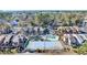 An aerial view showcases a community pool and tennis court within the townhouse complex at 614 15Th Ave. S # 42, Surfside Beach, SC 29575
