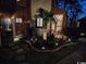 Exterior nighttime view, with landscape lighting and fenced front patio at 614 15Th Ave. S # 42, Surfside Beach, SC 29575