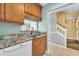 Kitchen view features granite countertops, wooden cabinets, and modern appliances at 614 15Th Ave. S # 42, Surfside Beach, SC 29575