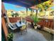 Inviting patio with dining table, chairs, lush greenery, and view of neighboring homes at 614 15Th Ave. S # 42, Surfside Beach, SC 29575
