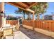 Outdoor patio with a table, chairs, plants and gate leading to a fenced yard at 614 15Th Ave. S # 42, Surfside Beach, SC 29575