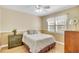 Bright bedroom with a comfortable bed, dresser, and natural light at 6634 Cinnamon Fern Ln., Myrtle Beach, SC 29588