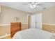 Bright bedroom featuring light hardwood floors, white trim, and inviting decor at 6634 Cinnamon Fern Ln., Myrtle Beach, SC 29588