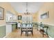 Bright dining room area with a modern chandelier and an abundance of natural light at 6634 Cinnamon Fern Ln., Myrtle Beach, SC 29588