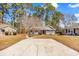 A charming home with a gray exterior, a red front door, and a well-manicured front yard at 6634 Cinnamon Fern Ln., Myrtle Beach, SC 29588