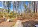 Tranquil stone garden path leading through lush greenery and an elegant metal archway at 6634 Cinnamon Fern Ln., Myrtle Beach, SC 29588