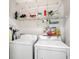 Functional laundry room with washer, dryer, and shelving at 6634 Cinnamon Fern Ln., Myrtle Beach, SC 29588