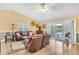 Bright living room featuring vaulted ceilings and sliding doors leading to the backyard patio at 6634 Cinnamon Fern Ln., Myrtle Beach, SC 29588