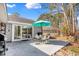 Inviting backyard patio with dining set and mature trees, perfect for outdoor living at 6634 Cinnamon Fern Ln., Myrtle Beach, SC 29588
