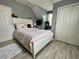 Cozy bedroom featuring a white bed frame, plush rug, and natural light from the window at 6636 Breezewood Blvd., Myrtle Beach, SC 29588