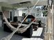 Relaxing covered patio featuring comfortable seating, a grill, and cozy hammock at 6636 Breezewood Blvd., Myrtle Beach, SC 29588
