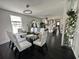 Sunlit dining room with seating for six, a modern chandelier and access to a white kitchen at 6636 Breezewood Blvd., Myrtle Beach, SC 29588