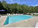 Community pool surrounded by lounge chairs and mature trees providing a serene outdoor recreational space at 6636 Breezewood Blvd., Myrtle Beach, SC 29588