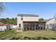 Spacious backyard with a screened-in porch, lush lawn, and mature trees offering shade at 813 Silvercrest Dr., Myrtle Beach, SC 29579