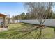 Green backyard with a healthy lawn, mature trees, and a white fence at 813 Silvercrest Dr., Myrtle Beach, SC 29579