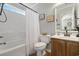 Bright bathroom featuring a shower-tub combo, framed mirror, and wooden vanity at 813 Silvercrest Dr., Myrtle Beach, SC 29579