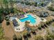 Aerial view of the community pool featuring a unique design, sun loungers, and covered seating areas at 813 Silvercrest Dr., Myrtle Beach, SC 29579
