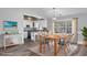 An open-concept dining room with wood flooring, light gray walls, and a wooden table at 919 Salt Pl., Murrells Inlet, SC 29576