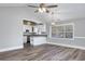 Open-concept dining room with wood flooring, light gray walls, and an open view into the kitchen at 919 Salt Pl., Murrells Inlet, SC 29576