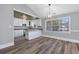 Open-concept dining room with wood flooring, light gray walls, and an open view into the kitchen at 919 Salt Pl., Murrells Inlet, SC 29576