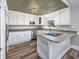 Modern kitchen featuring stainless steel appliances, white cabinets, and wood flooring at 919 Salt Pl., Murrells Inlet, SC 29576