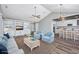 An open-concept living room and kitchen with wood flooring, white cabinets, and a vaulted ceiling at 919 Salt Pl., Murrells Inlet, SC 29576