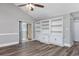 Spacious living room featuring wood floors, built-in shelving, and sliding door access to the outdoors at 919 Salt Pl., Murrells Inlet, SC 29576