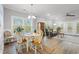 Charming dining area filled with natural light and beautiful hardwood flooring, leading to a comfortable living space at 933 Jackline Place # 101, Murrells Inlet, SC 29576