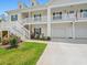 Close-up of inviting condo exterior with lush landscaping and a private garage at 933 Jackline Place # 101, Murrells Inlet, SC 29576