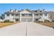 Charming two-story condo featuring double balconies and private garages at 933 Jackline Place # 101, Murrells Inlet, SC 29576