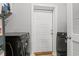 Convenient laundry area with modern black washer and dryer machines next to a white door at 933 Jackline Place # 101, Murrells Inlet, SC 29576