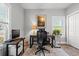 Modern home office with neutral walls, natural light, and an ergonomic chair at 933 Jackline Place # 101, Murrells Inlet, SC 29576
